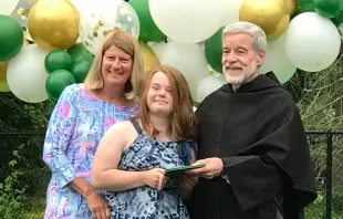 Pastor of St. Augustine's, Fr. Peter Gori O.S.A. (right) and admissions director Paula O'Dea (left) hand Abby Aguedelo her diploma on graduation day. Wendy Agudelo